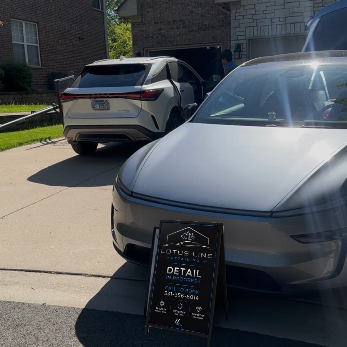 Mobile detailing setup at a residential location with professional equipment